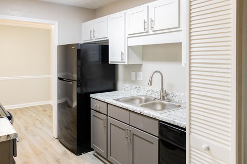 Modern kitchen with grey and white cabinets at Twin Springs, Norcross, GA
