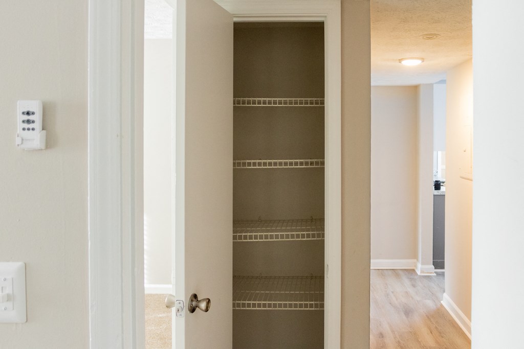 Hallway closet with shelving at Twin Springs Apartments, Norcross, GA