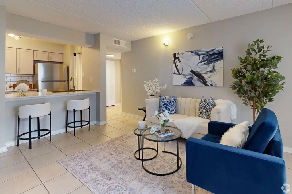 A living room with a blue couch and a coffee table.