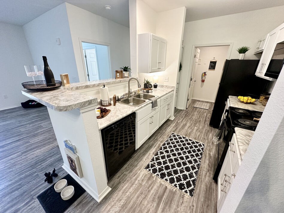 A kitchen with a white island and a sink.