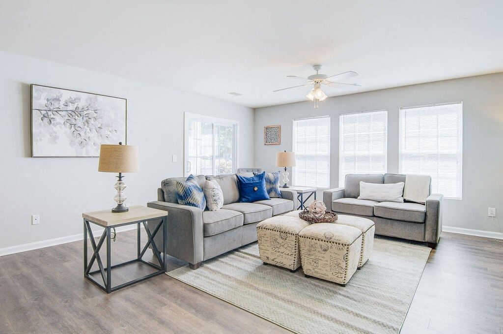 a living room with white walls and a ceiling fan at Enclave at West Ashley Apartments, Charleston,32304