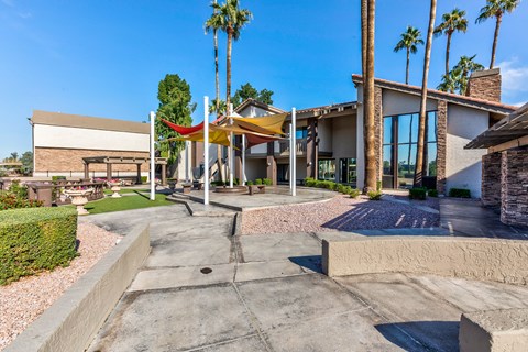 Outdoor seating near clubhouse with a lake view