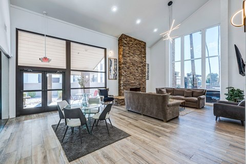 A modern living room with a glass table and chairs.