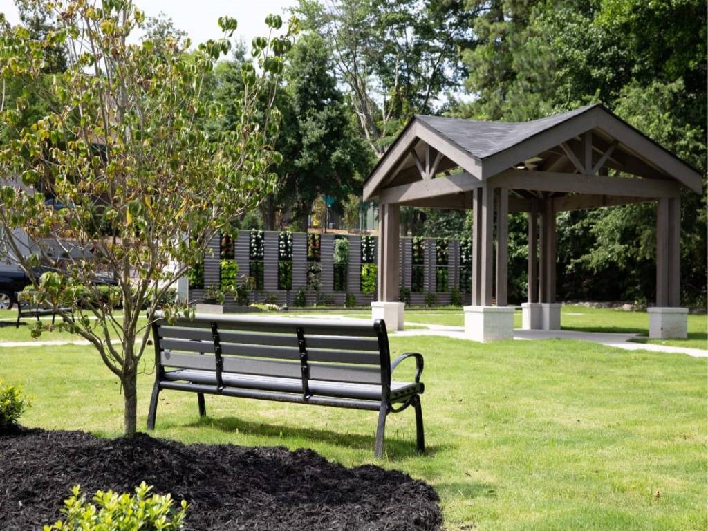 a park bench sitting in front of a gazebo