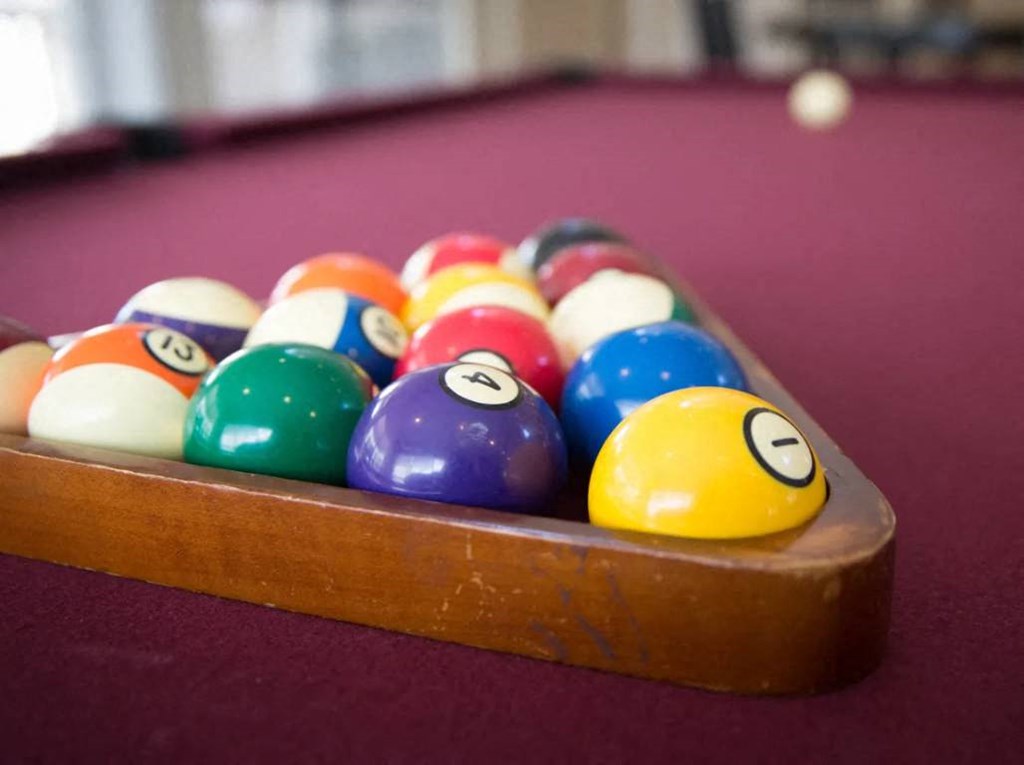 a game of pool balls on a red table