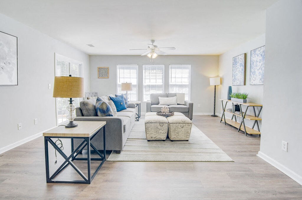 a living room with white walls and a ceiling fan at Enclave at West Ashley Apartments, Charleston, SC, 29414