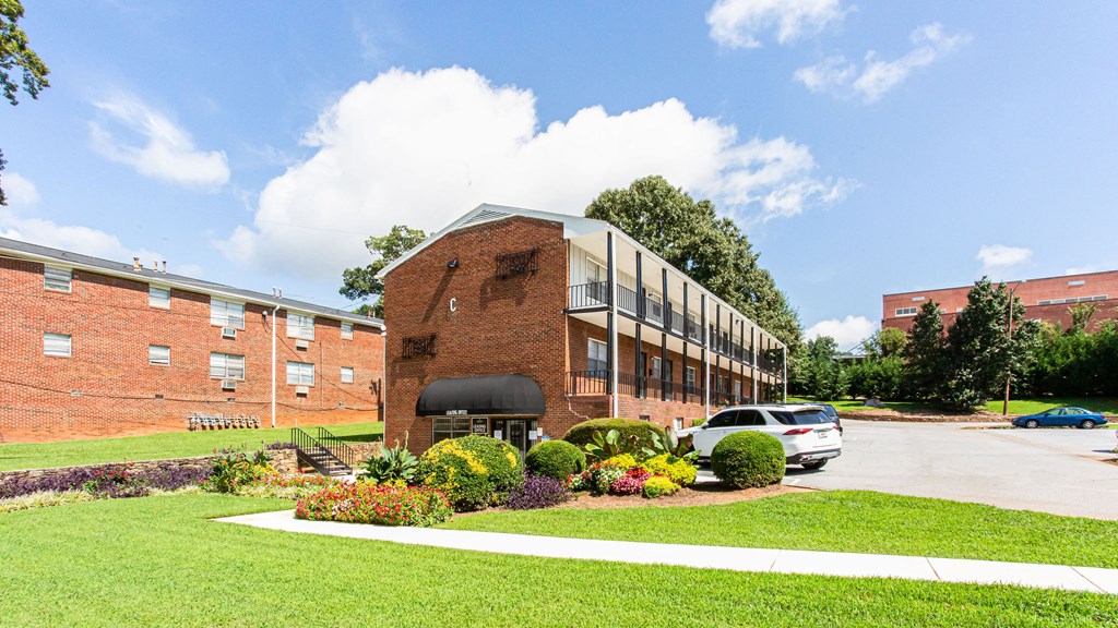 a large brick building with a parking lot in front of it