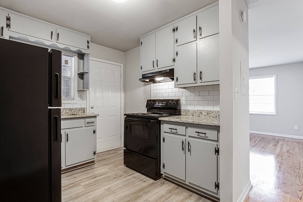 1295 west kitchen with white cabinets and black appliances