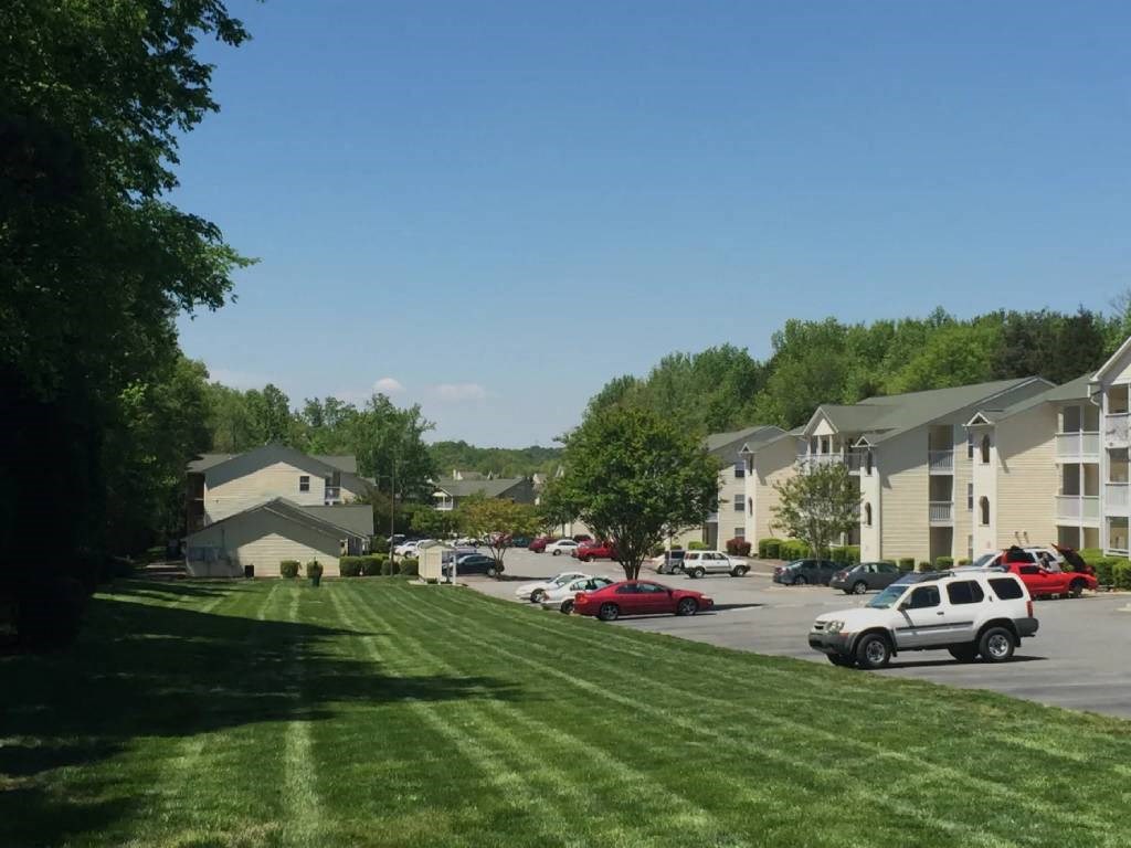 a suburban neighborhood with cars parked in a parking lot