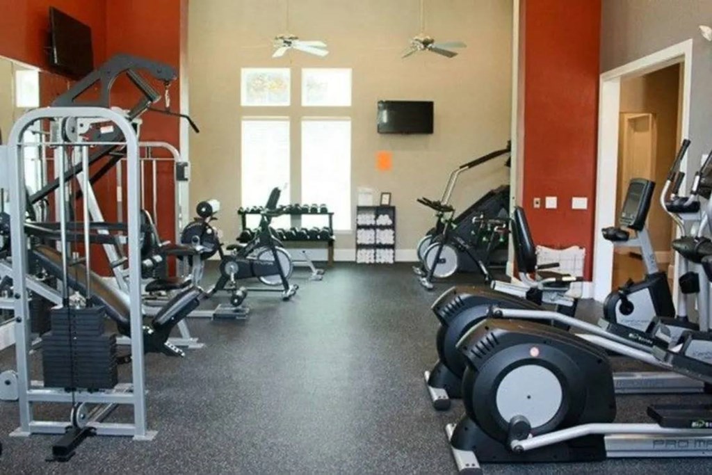 a gym with a lot of exercise equipment in it at Kings Cove, Kingwood, 77345