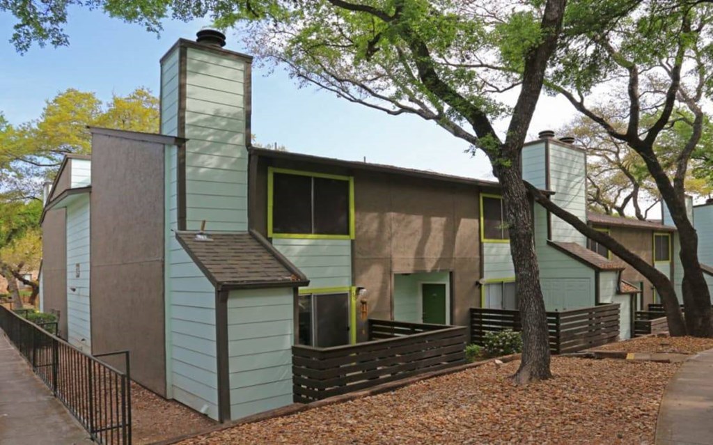 a row of houses with trees in front of them at Elevate at Huebner Grove, San Antonio Texas
