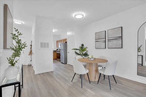 A modern dining room with a round table and chairs.