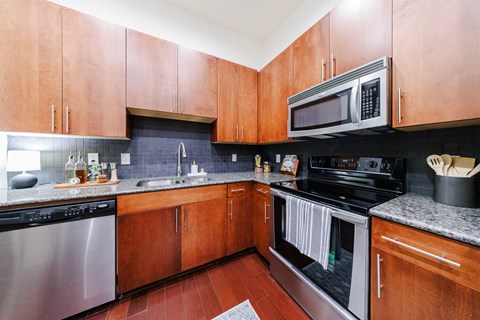 A kitchen with wooden cabinets and stainless steel appliances.