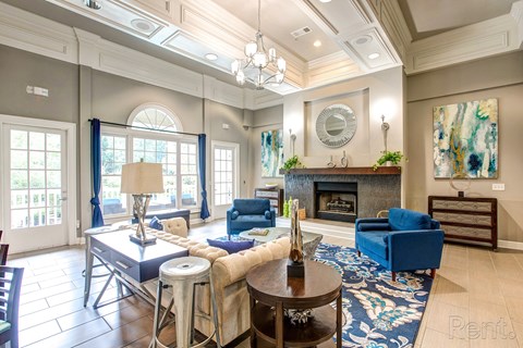 a living room with blue furniture and a fireplace