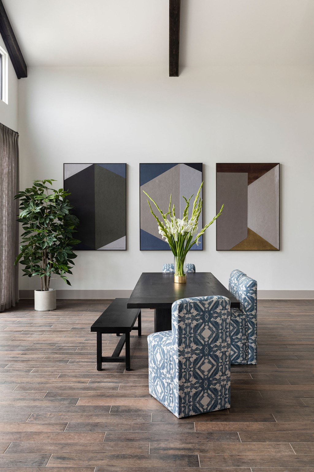 a dining room with a table and a chair and some paintings on the wall at The Cannon, Murfreesboro, 37130