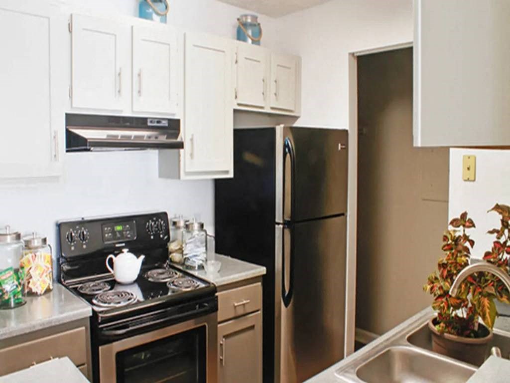 a kitchen with stainless steel appliances and white cabinets