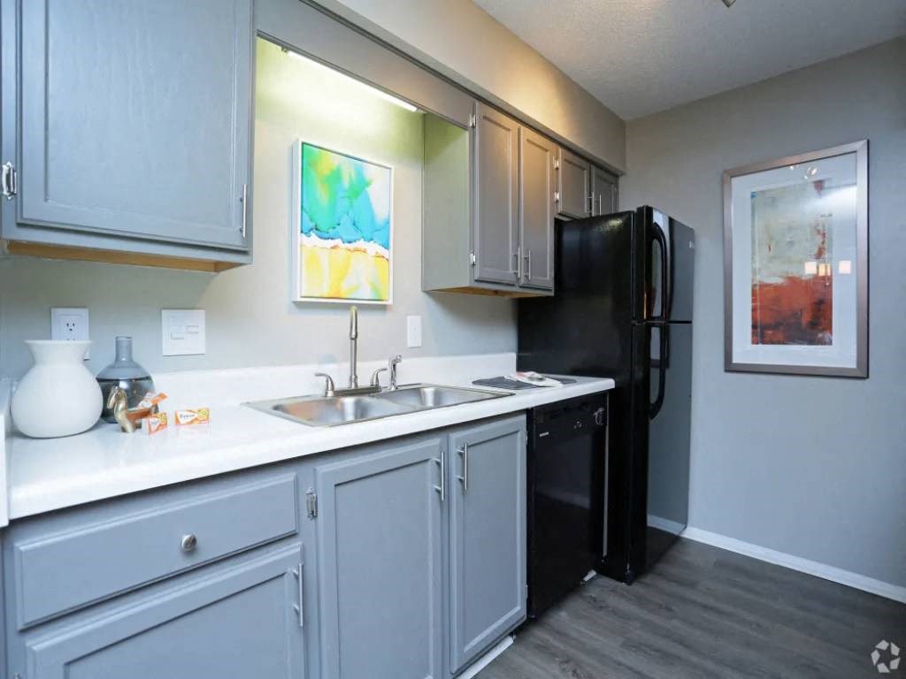 a kitchen with a sink and a refrigerator
