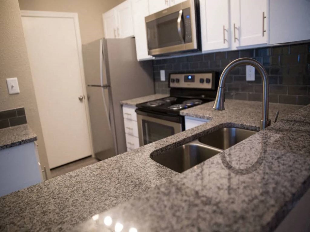 a kitchen with granite counter tops and a sink