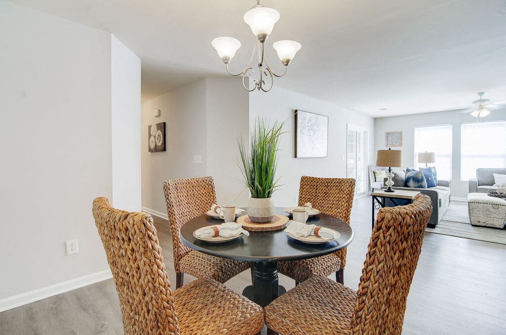 a dining room with a table and chairs at Enclave at West Ashley Apartments, Charleston