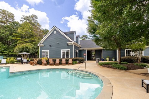 Sparkling swimming pool with new poolside lounge chairs at The Grove at Greenleaf Apartments