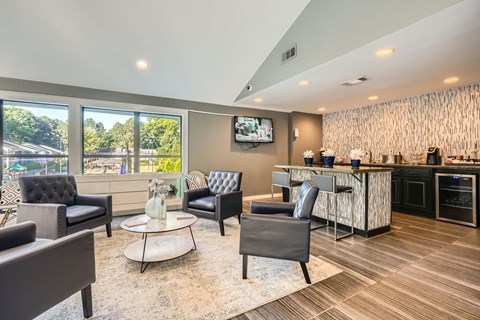 A modern living room with a bar area and a television.