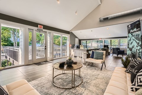 A living room with a white couch and a coffee table in the center.