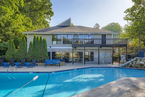 A house with a pool in front of it.