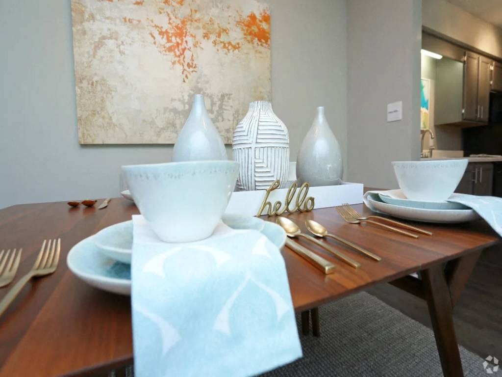 a dining room table with a bowl and plates on it