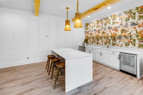 Kitchen with white cabinets and a white island at Crescent Place Apartments, Georgia, 31419