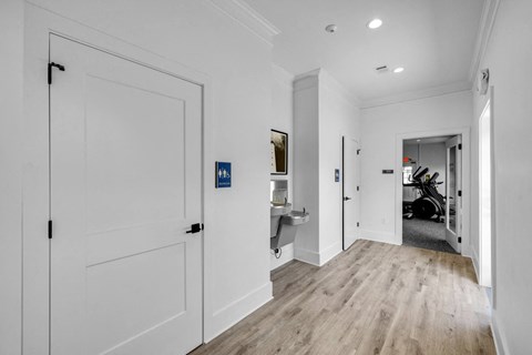 Hallway with white closets and doors at Crescent Place Apartments, Savannah, 31419