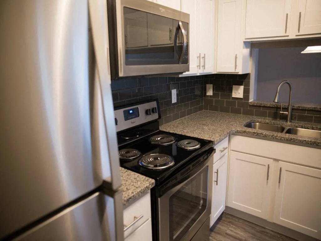 a kitchen with stainless steel appliances and white cabinets