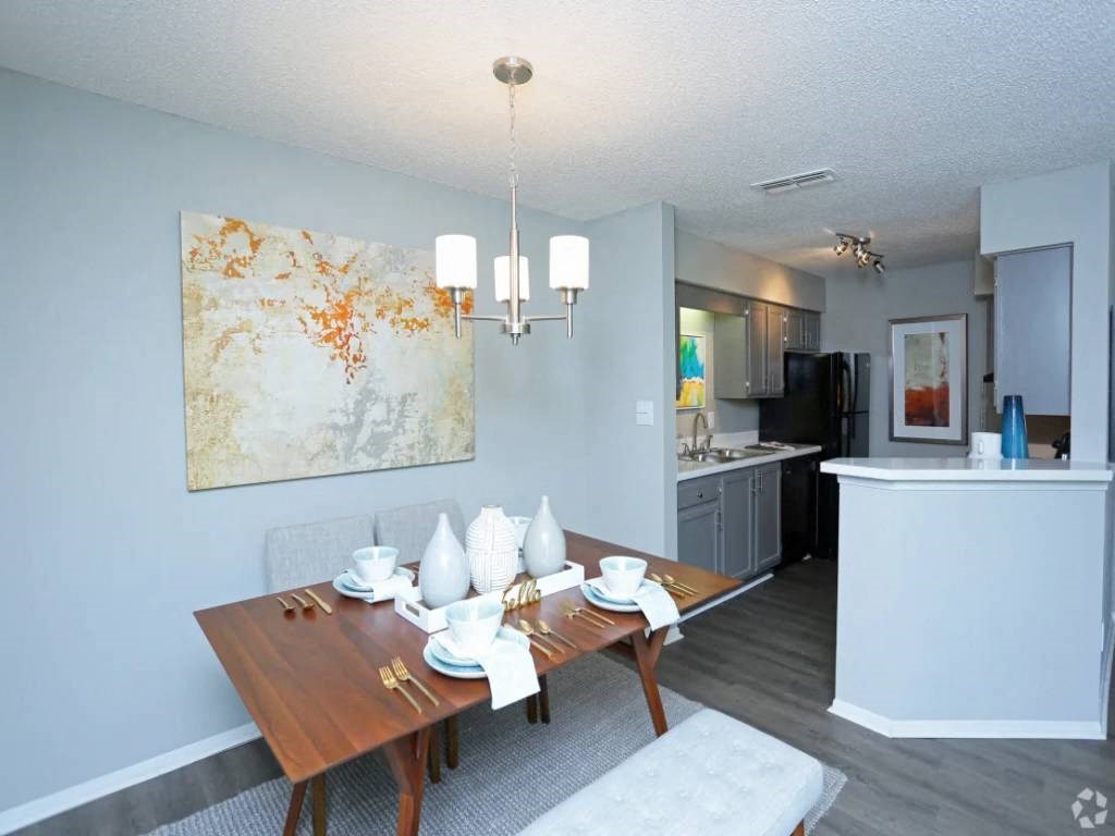 a dining room with a table and chairs and a kitchen