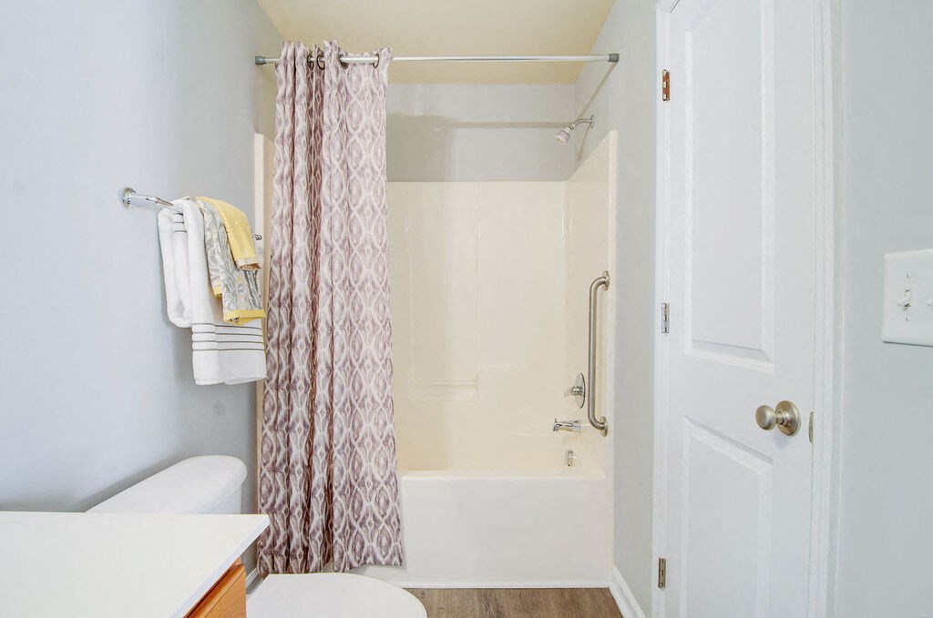 a bathroom with a shower and a toilet at Enclave at West Ashley Apartments, Charleston