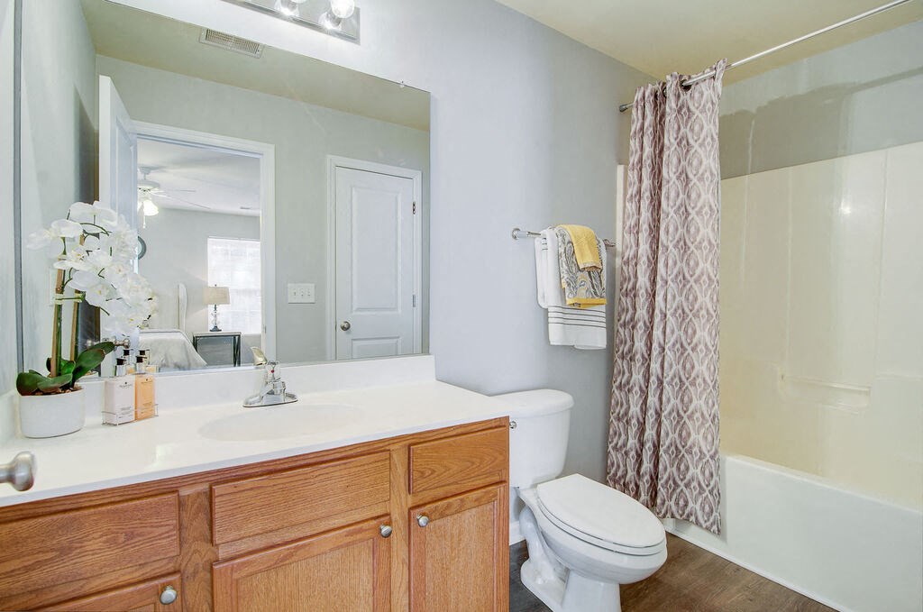 a bathroom with a sink toilet and shower at Enclave at West Ashley Apartments, Charleston