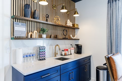 A kitchen with blue cabinets and a white countertop.