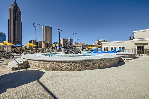 A roundabout with a fountain in the middle of a city square.
