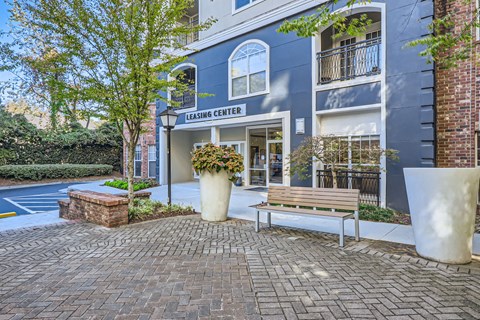 A brick building with a sign that says Leasing Center.
