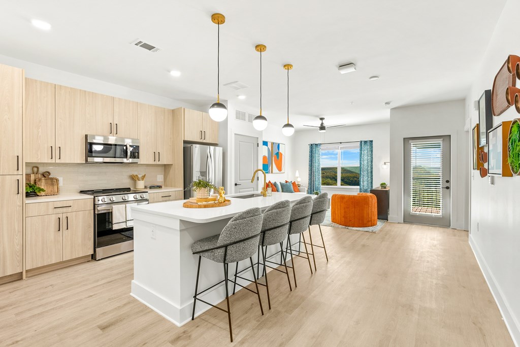 A kitchen with a white island and wooden cabinets.