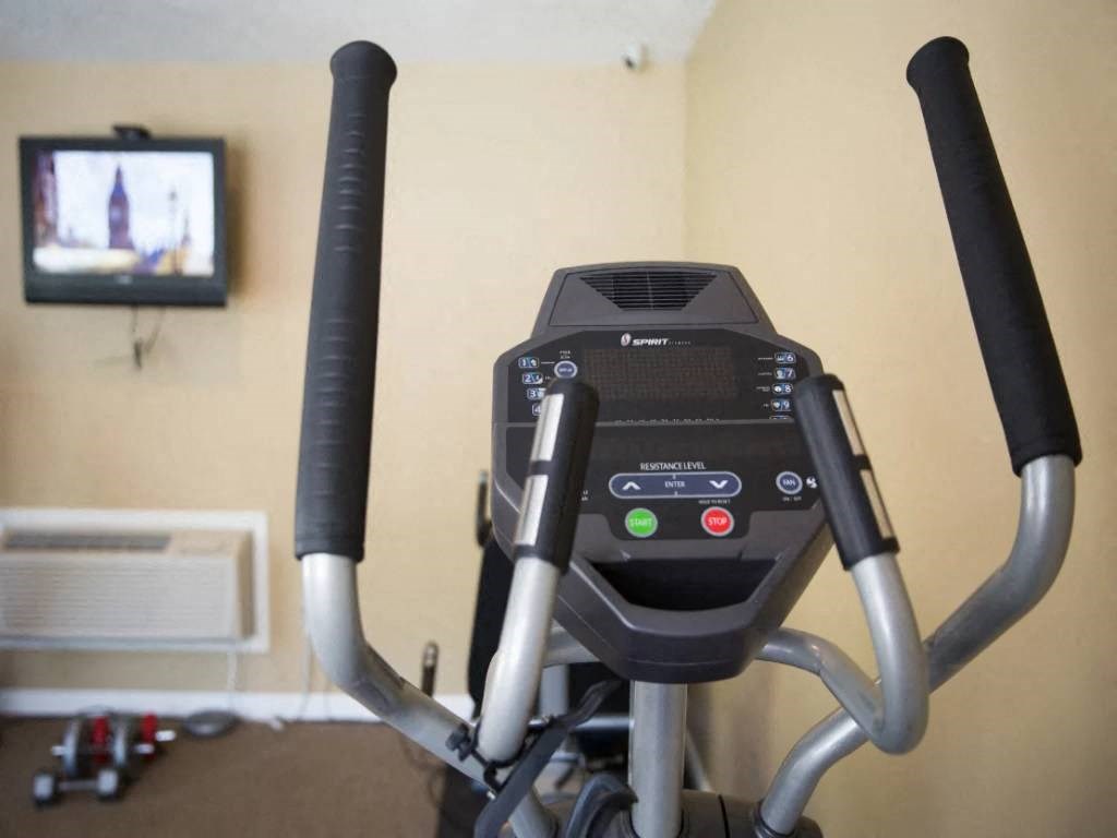 a treadmill in a gym with a tv on the wall