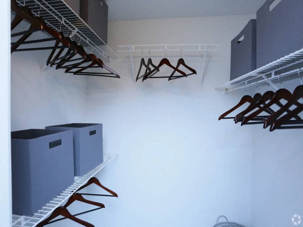 a rack of ski gear in a room with a white wall