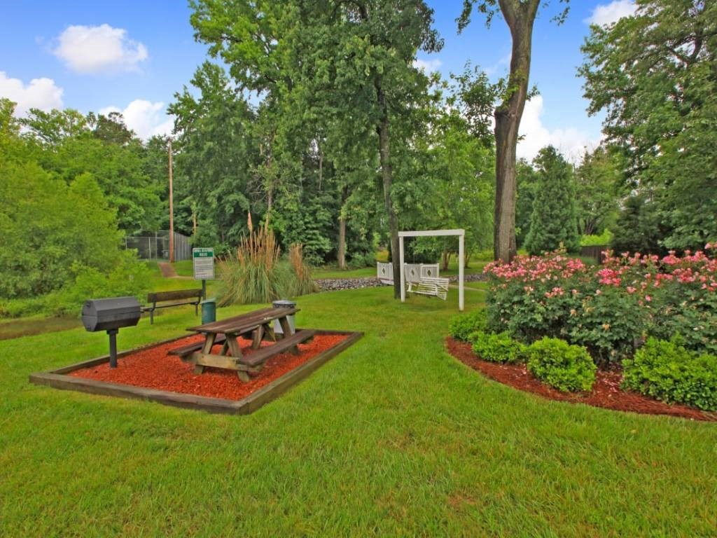 a park with a picnic table and a bench