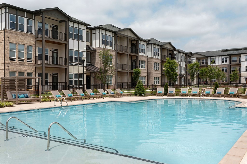 an apartment swimming pool in front of an apartment building at The Cannon, Tennessee, 37130