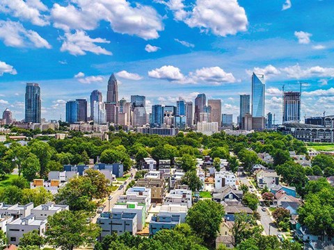 a view of a city skyline with trees and buildings