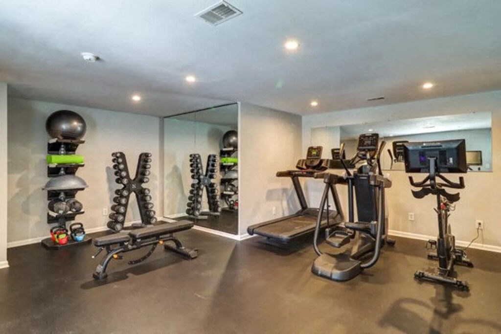 a home gym with a treadmill and weights at Enclave at West Ashley Apartments, Charleston,32304
