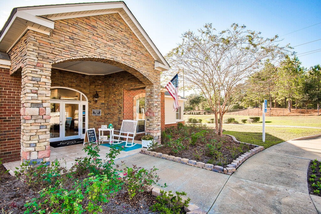 A house with a flag on the front lawn.