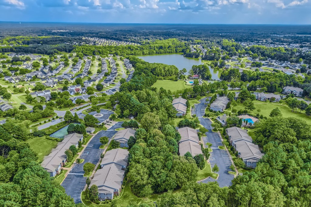 an aerial view of a neighborhood of houses next to a lake