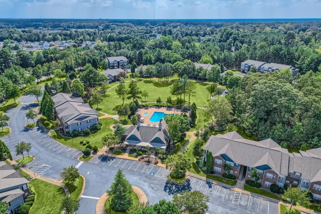 an aerial view of a neighborhood with houses and a swimming pool