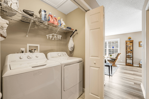 a washer and dryer in a laundry room with a door open to a