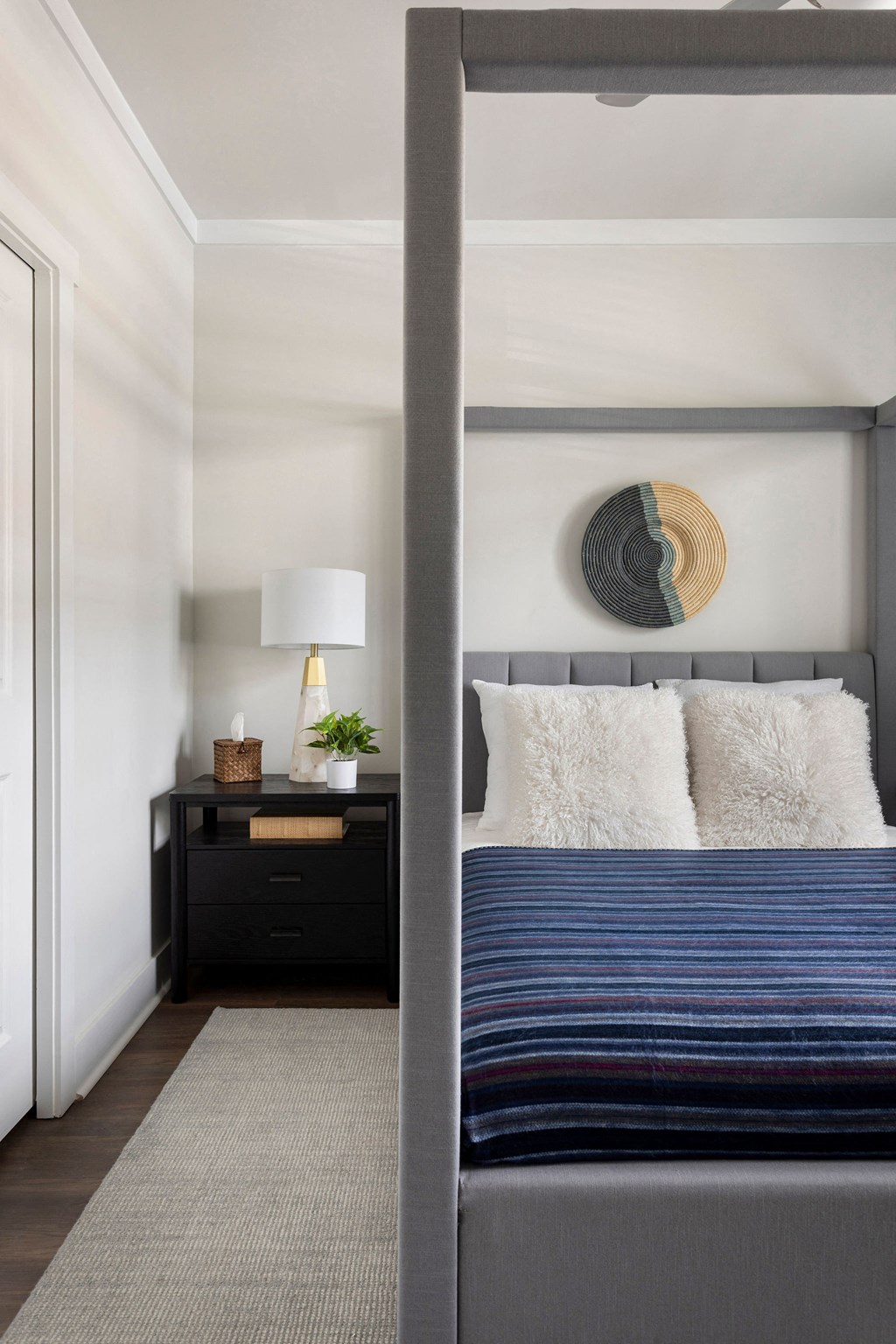 a bedroom with a bed and a nightstand with a lamp and a window at The Cannon, Murfreesboro, TN