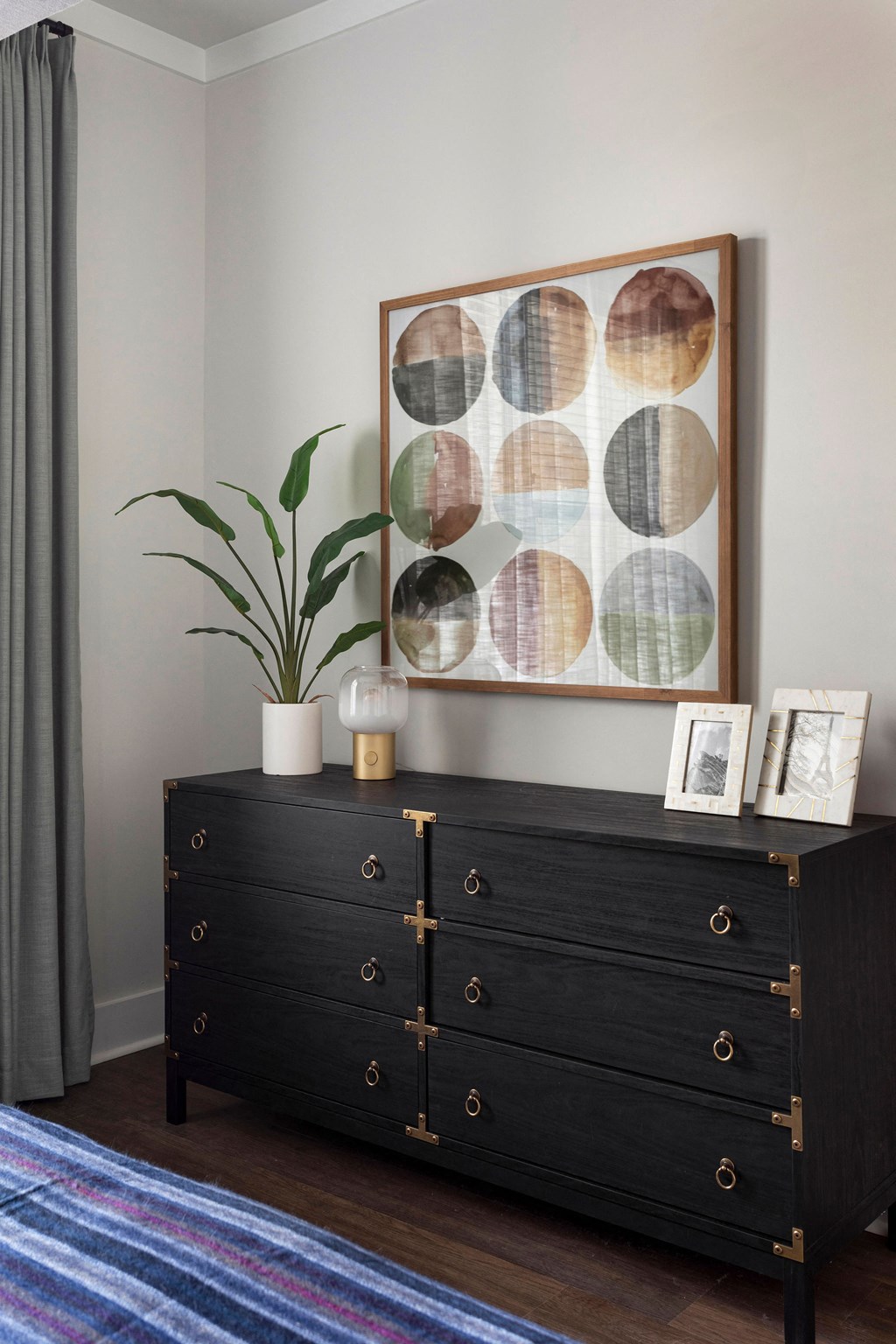 a dresser in a bedroom with a painting on the wall at The Cannon, Murfreesboro Tennessee